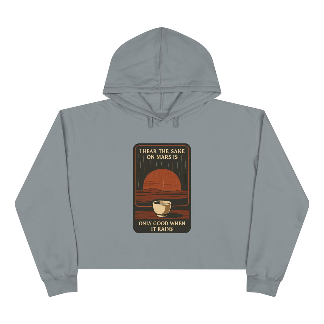 Mars Sake Crop Hoodie featuring a retro graphic of a Martian horizon with a steaming cup and text reading 'I Hear the Sake on Mars Is Only Good When It Rains'