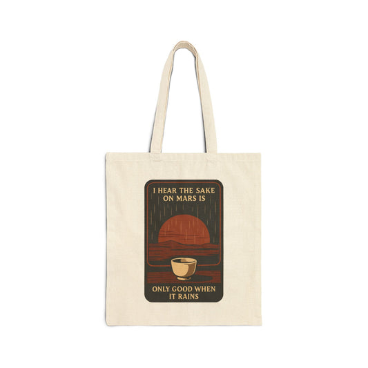 A cotton canvas tote bag featuring a retro sunset over a sake cup with the phrase 'I hear the sake on Mars is only good when it rains'.